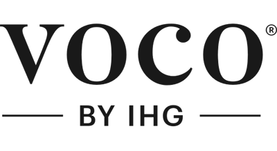 The image shows a logo with the name "Voco hotel " written in black letters.The background is white